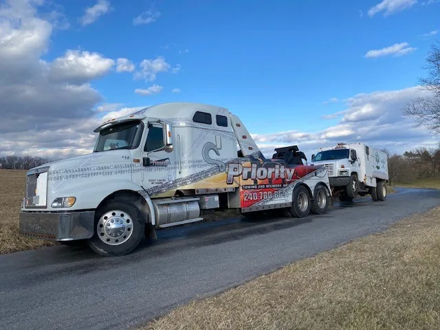 Priority Towing heavy wrecker towing a commercial truck