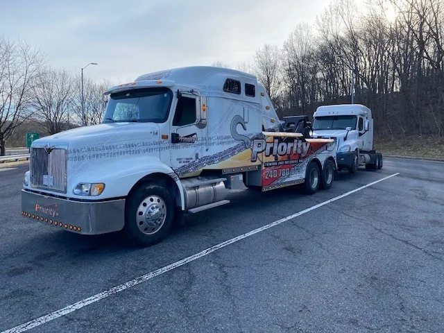 Priority Towing heavy wrecker recovering a tractor on a Maryland highway