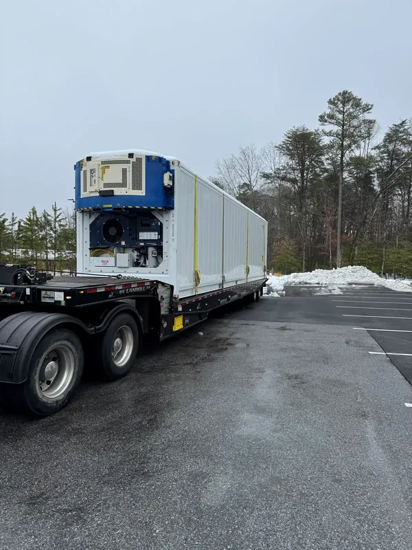 Priority Towing Landoll hauling a refrigerated container