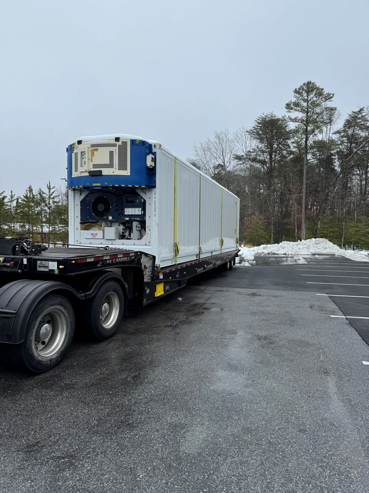 Priority Towing Landoll hauling a refrigerated container