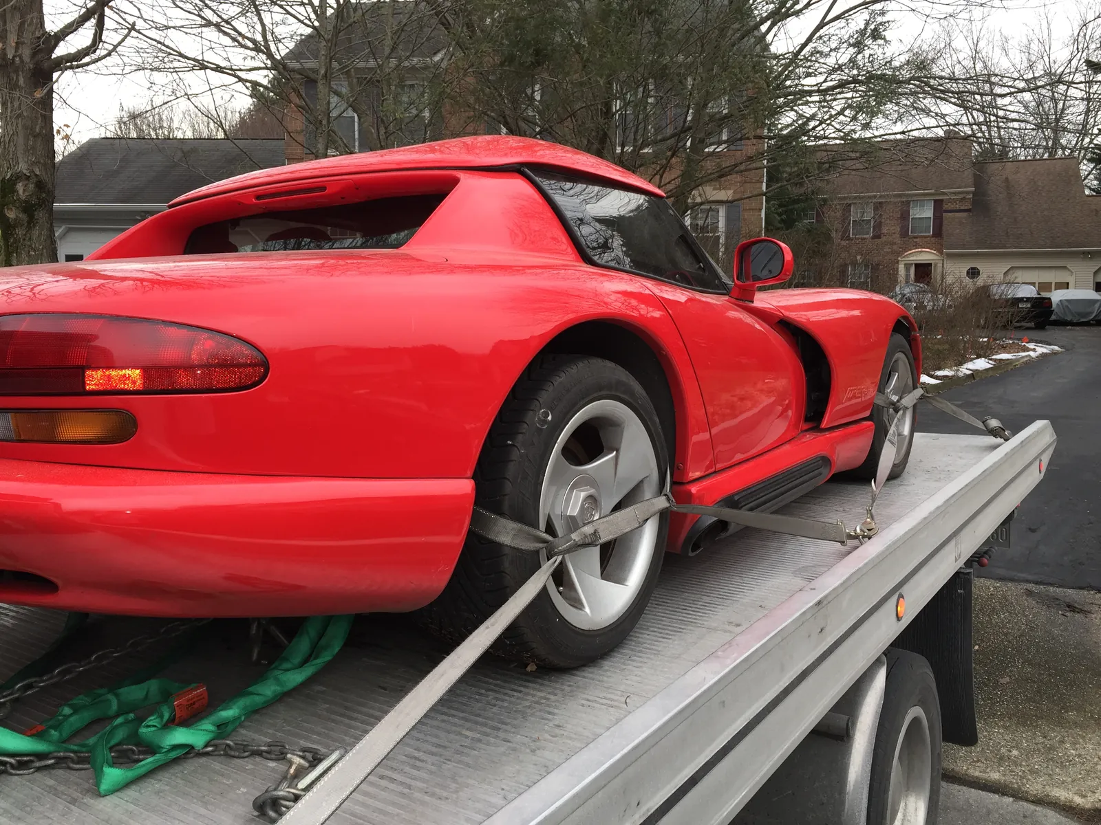 Sports car strapped on a rollback